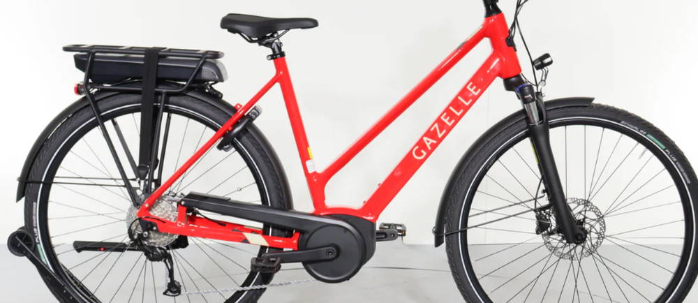A red Gazelle Medeo T9 HMB Mid Step electric step through city bike