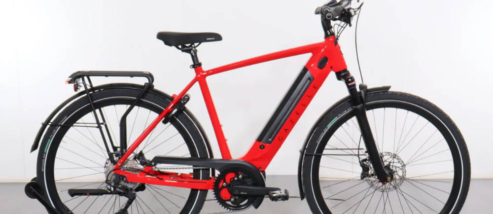 a red Gazelle Ultimate T10+ electric commuter bike