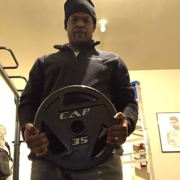 athlete shows his CAP weight plate