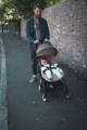 Pram style sheepskin liner in a babyzen yoyo with a baby on it being pushed by the baby's dad