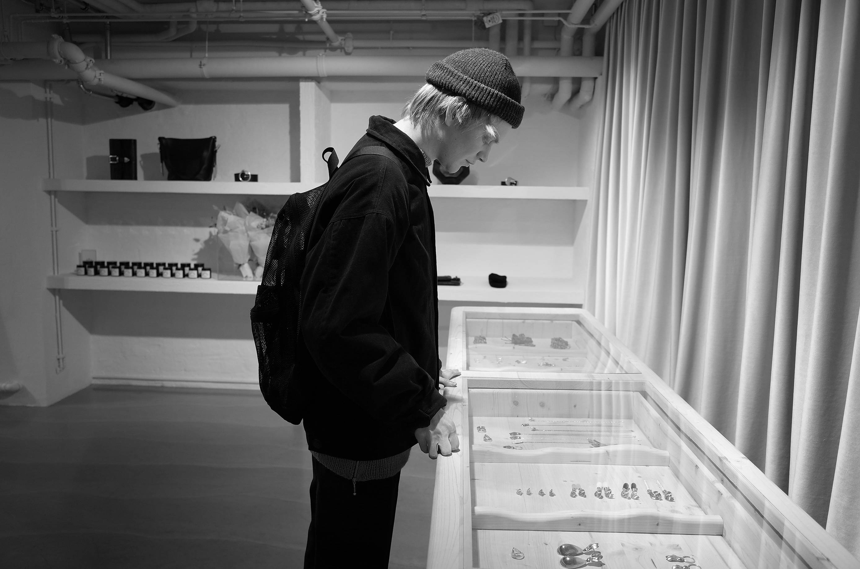 Image - A man looking at some items in a display-case