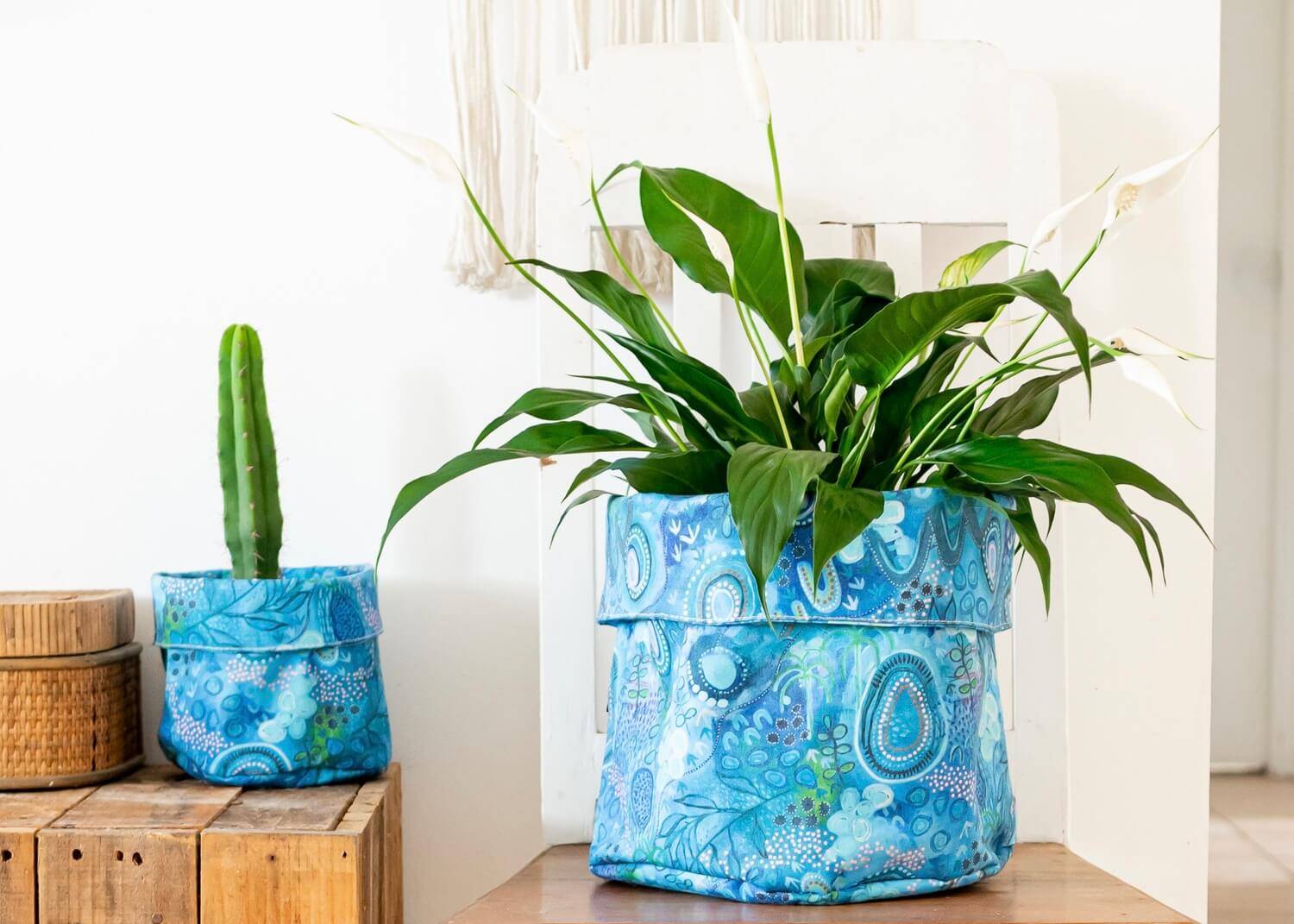 Small and large plant pots made with Indigenous artworks