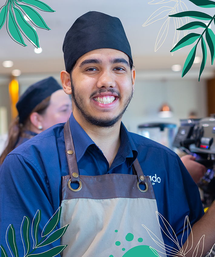 Smiling barista looking at the camera.