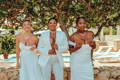 Three women standing together wearing their adhesive wedding bras