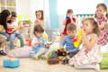 Kids playing musical instruments in a Montessori playroom.