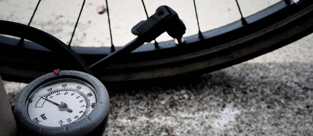 Bicycle floor pump with analog gauge inflating tire