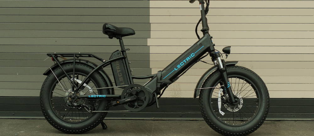 Electric bike Lectric in front of two-tone wall