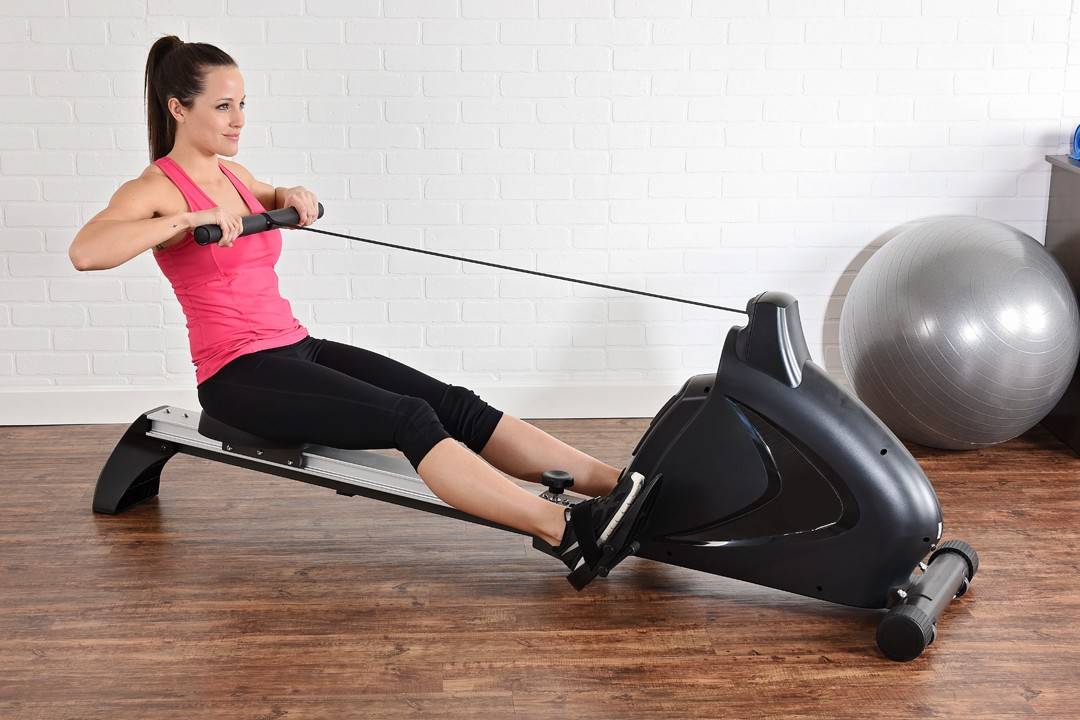 Women Training on Rowing Machine at Home