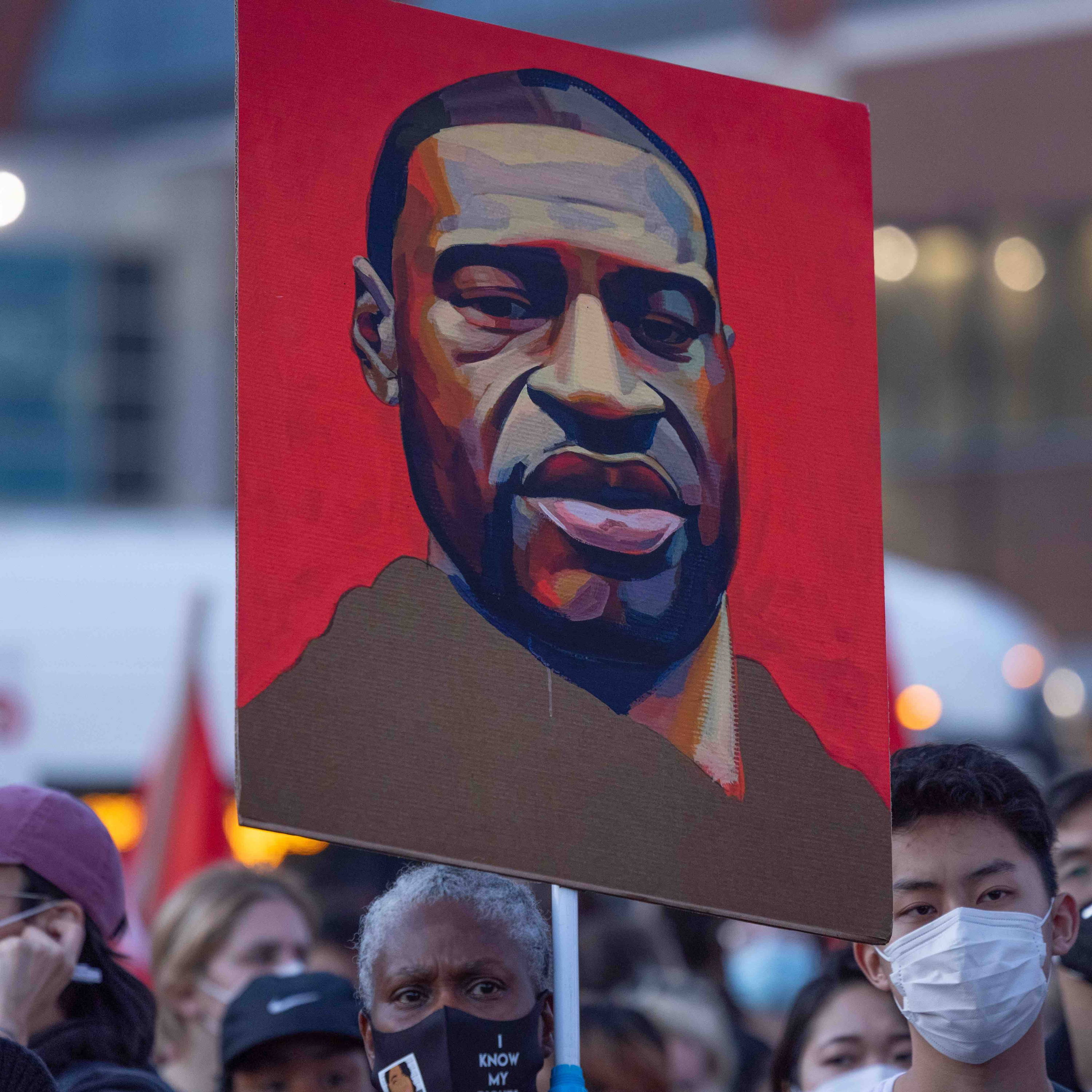 Red placard with illustration of George Floyd