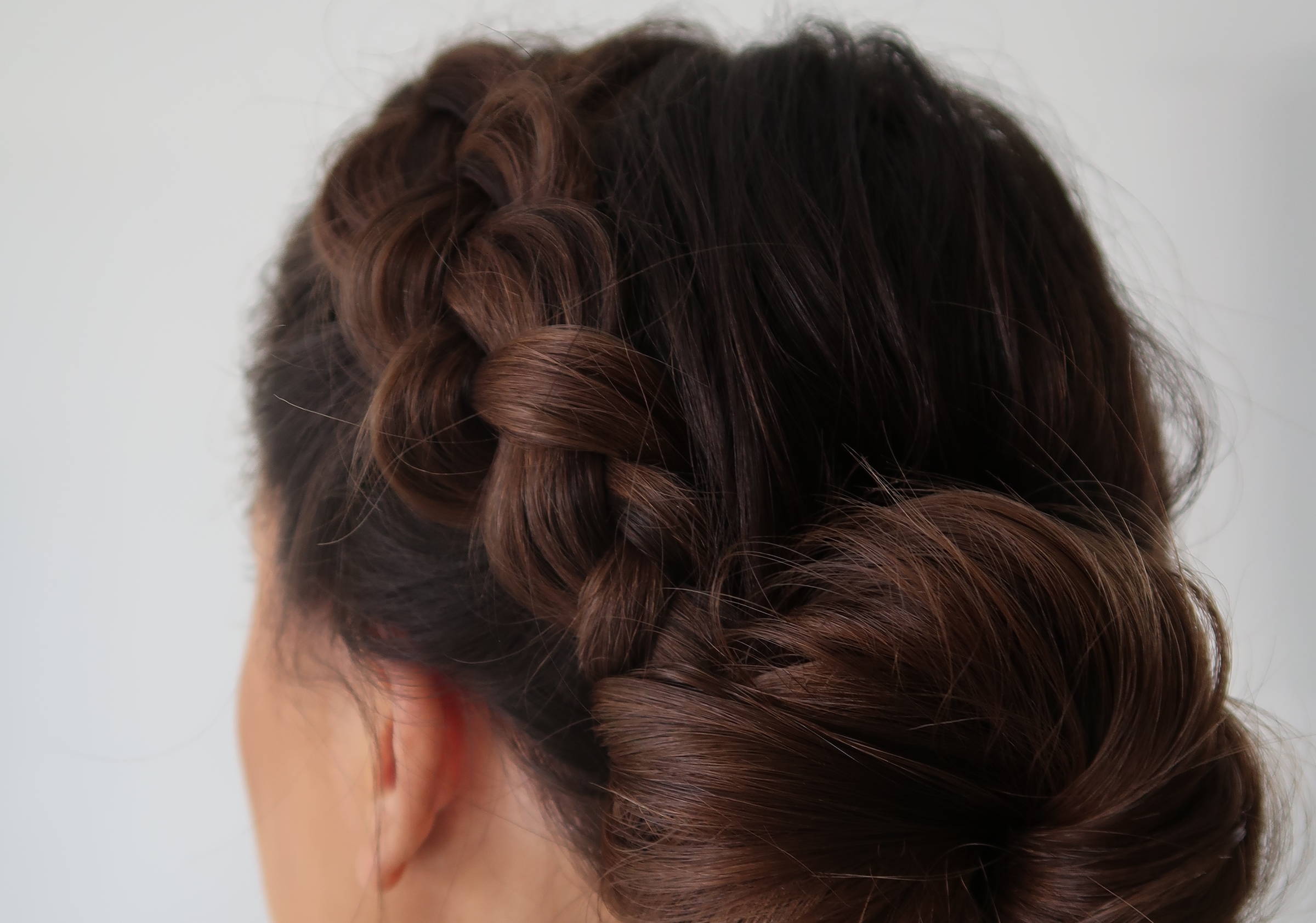 photo of backview of a blonde woman's hair in a low bun hairstyle