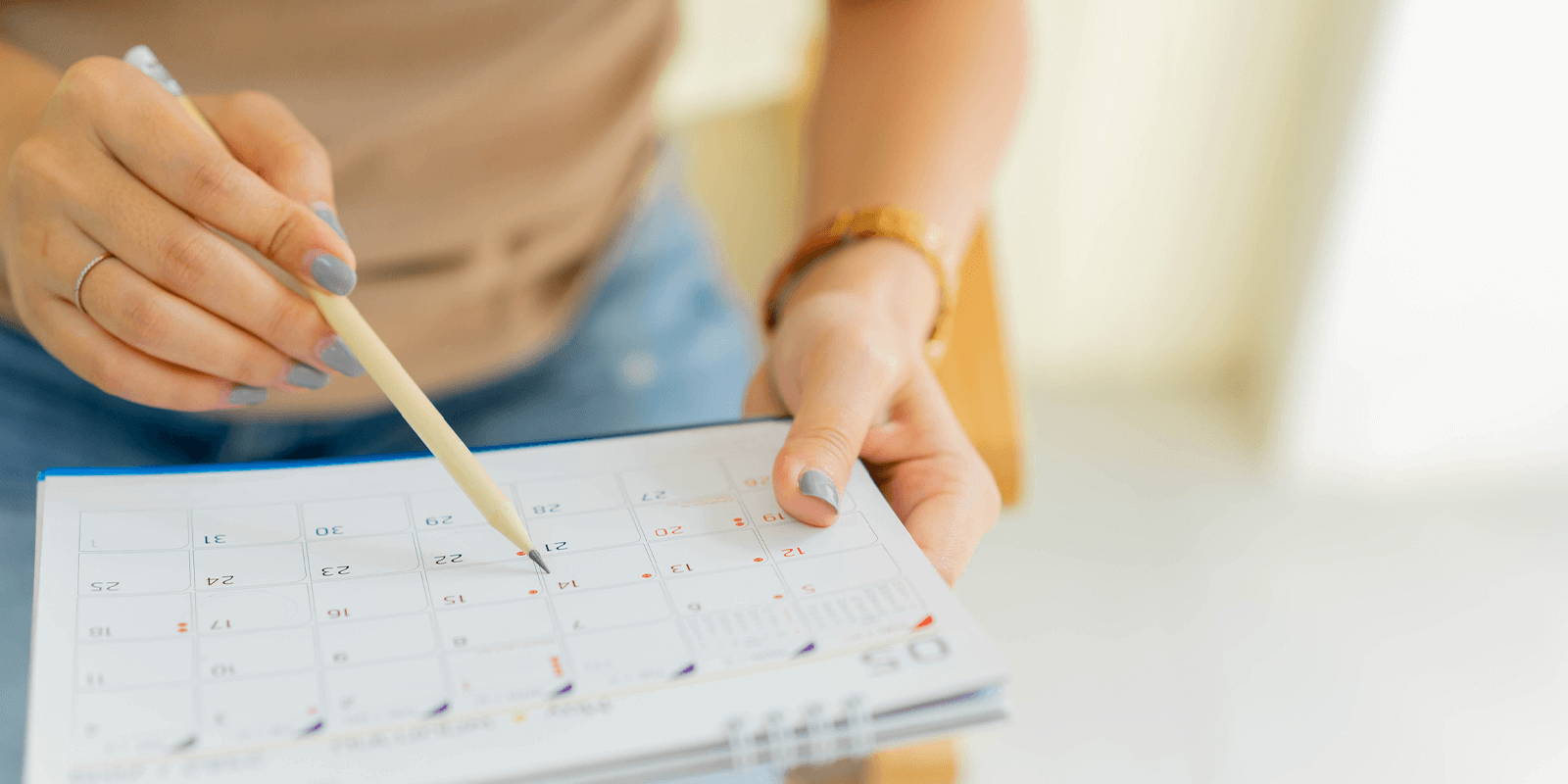 Woman marking on a calendar.