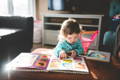 Little girl reading a book.