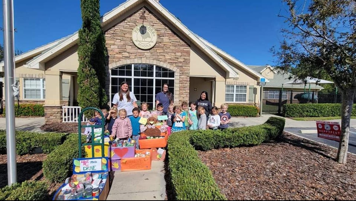 Photo of Primrose Kindergarteners posing with food donations