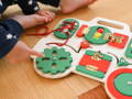 Baby's finger pointing at a Montessori-insipred Busy Board.