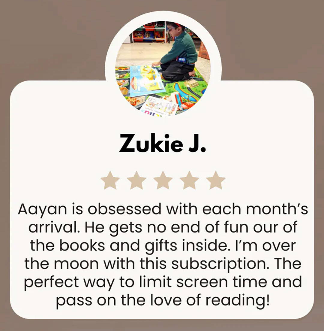 \Little boy reading a book from a Little Literates box