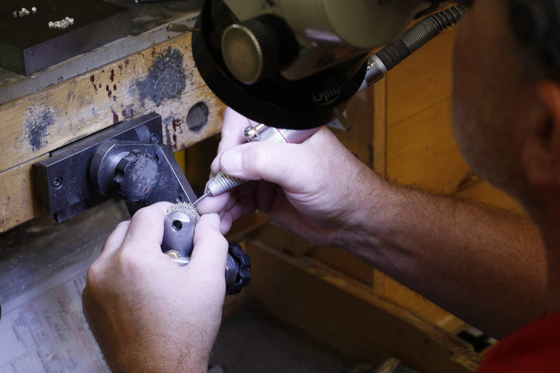 Jeweler inspecting prongs on a jewelry piece.