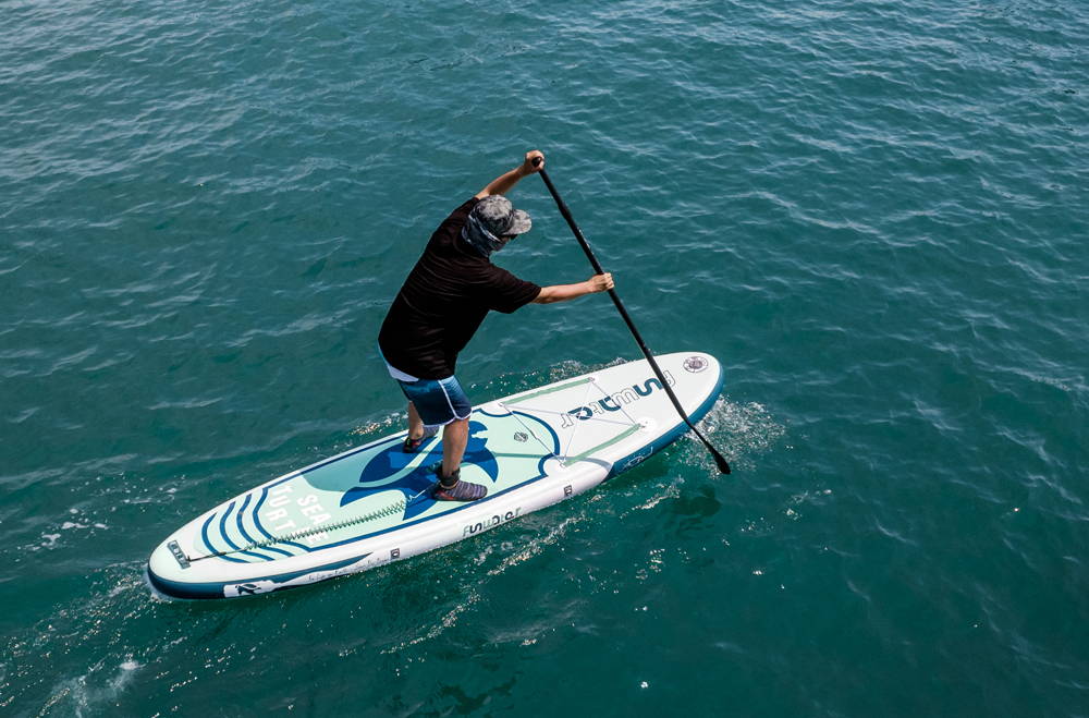 A man is paddleboarding