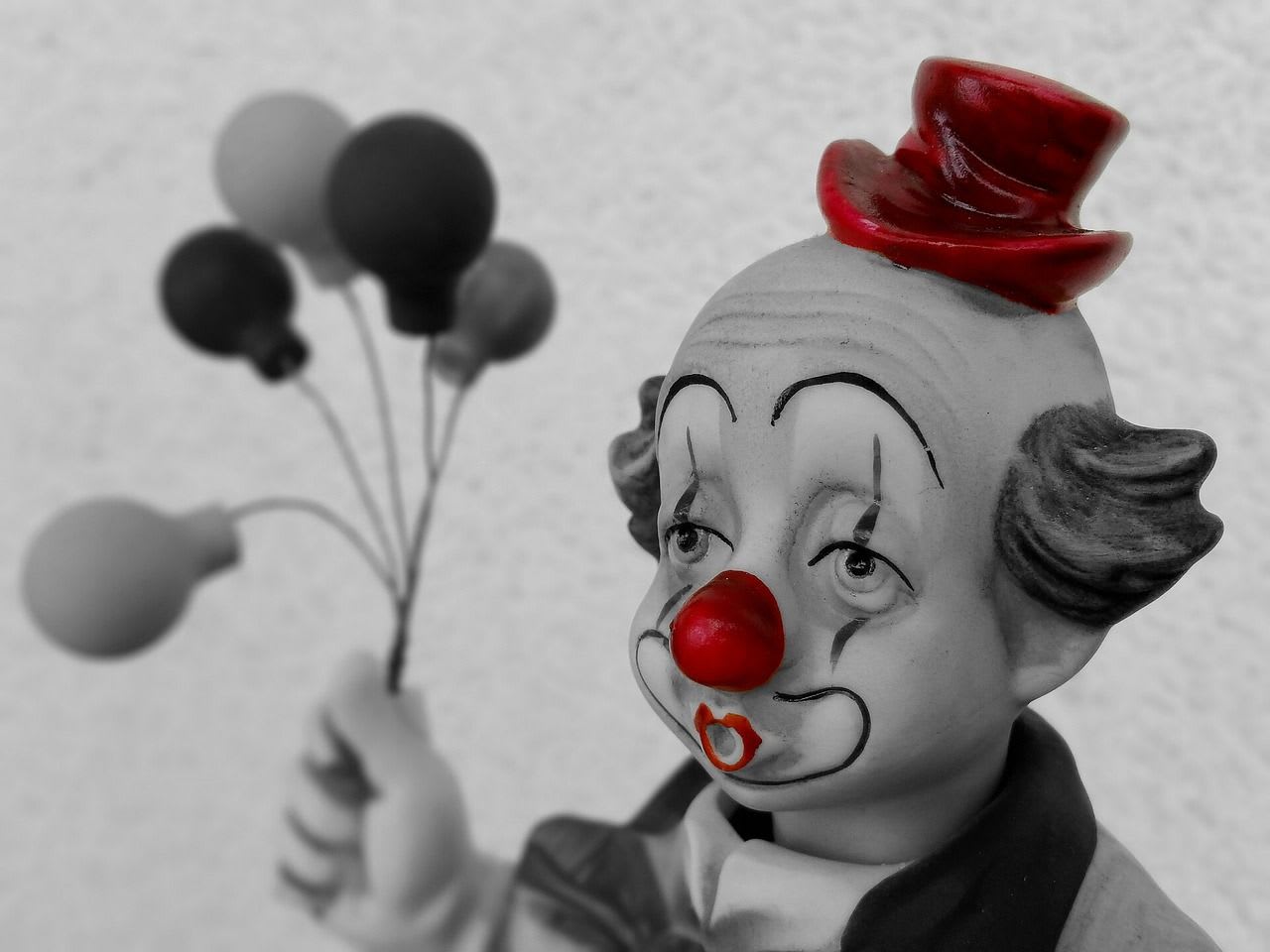 a clown figurine with a red nose