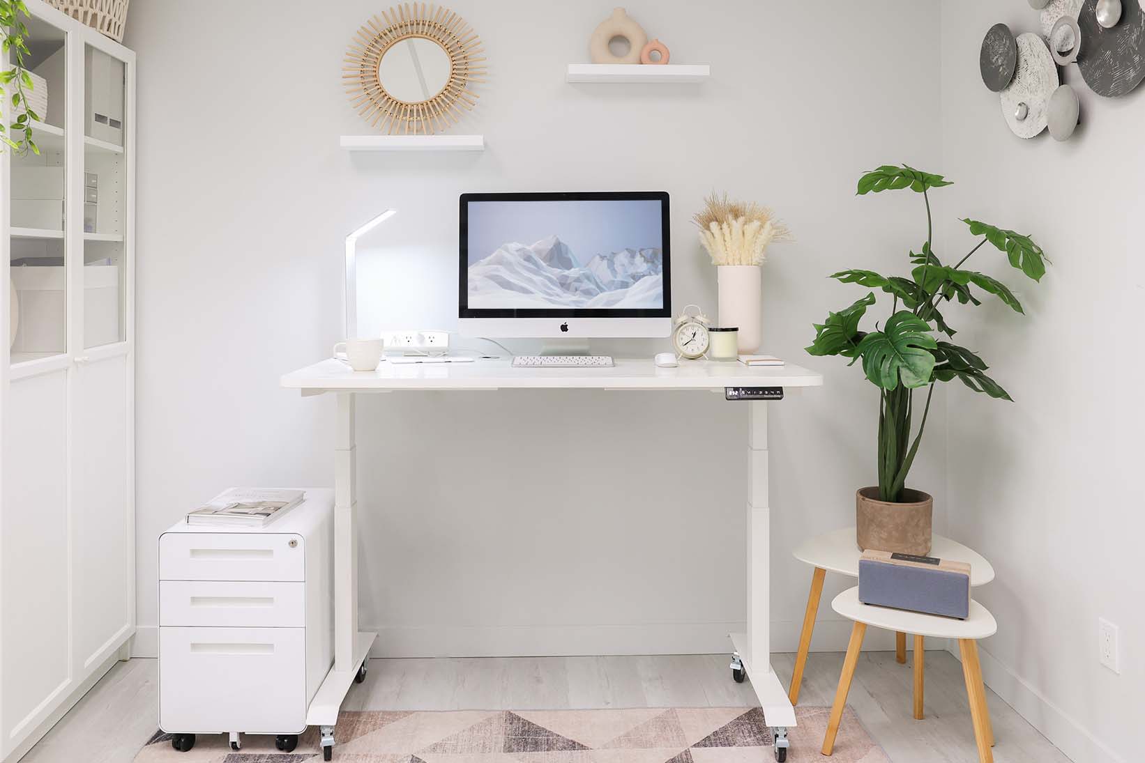 MotionGrey standing desk arranged in a bright home office