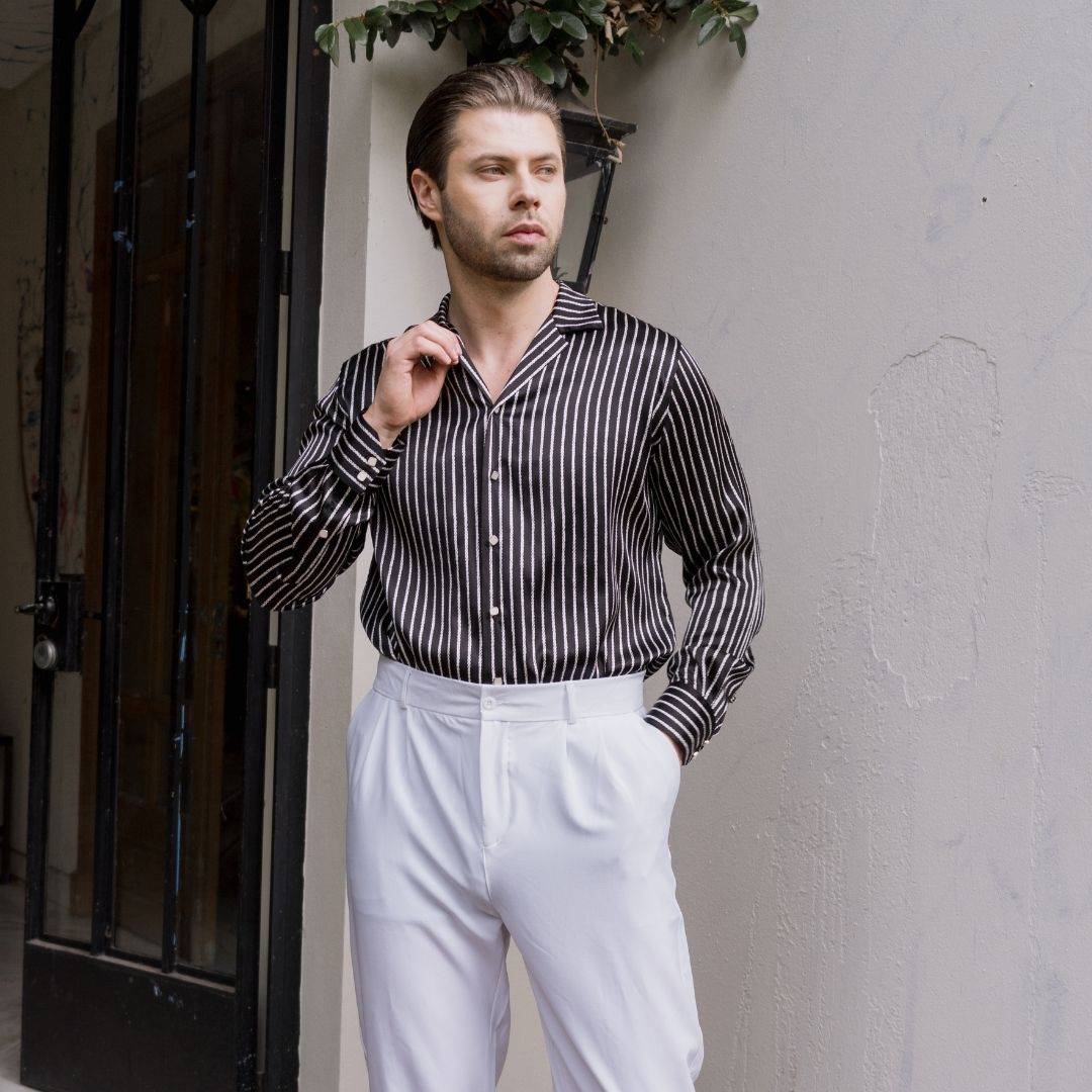 model wearing white pants and a long sleeve black stripe silk shirt from 1000 kingdoms