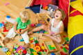 Joyful children playing with toys in a playroom.