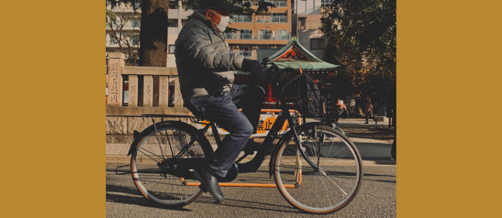 Older man riding a hybrid bike in Tokyo