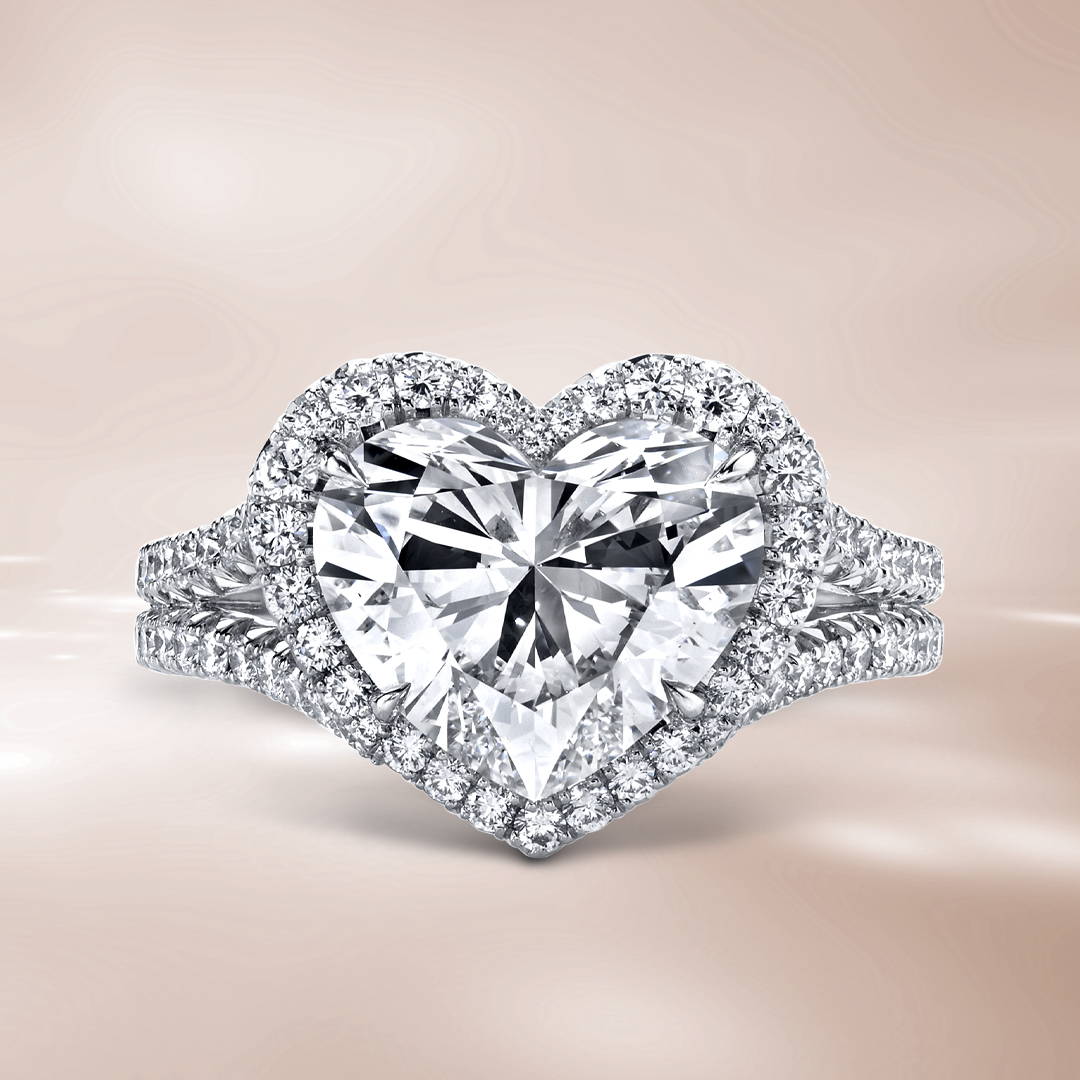 Heart shaped diamond engagement ring with round diamonds in a halo on a brown background.