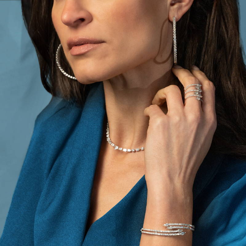 Woman wearing an assortment of diamond jewelry from Reis-Nichols Jewelers