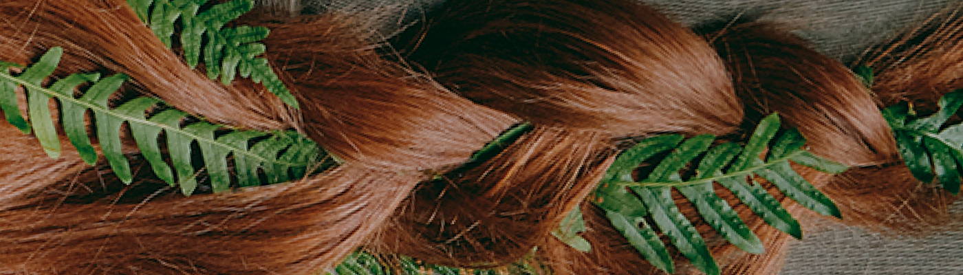 Davines LOVE Smoothing Shampoo, Instant Mask, and Perfector on a wooden bench