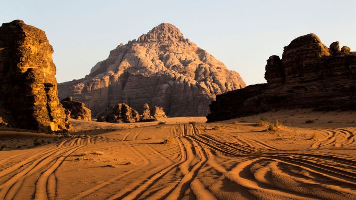 The landscape of Wadi Rum is dominated by its towering mountains, which rise from the desert floor like sentinels