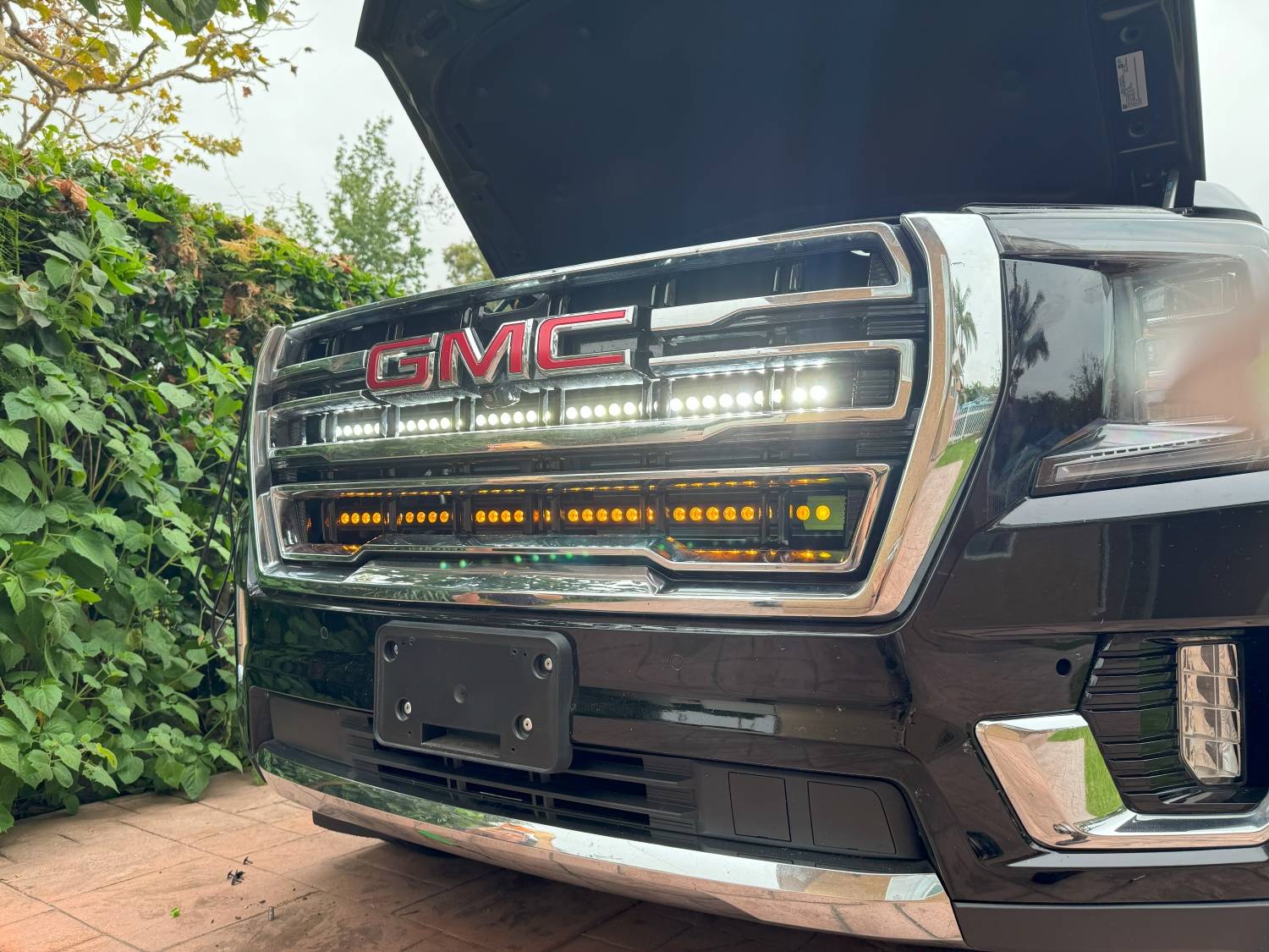 gmc yukon with two 40in white and amber light bars behind the grille  by mandr automotive
