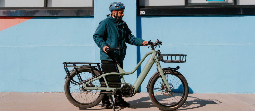 Momentum PakYak+ electric cargo bike and rider