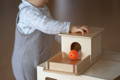 Baby playing with the wooden Montessori Object Permanence Box. 