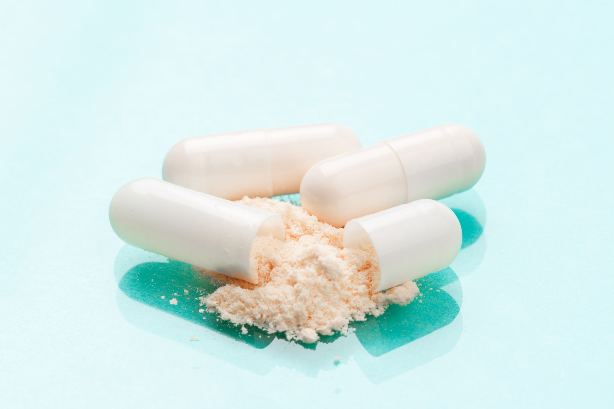 White medicine capsules probiotic powder inside
