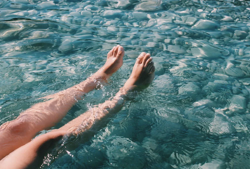 Highangle view of beautiful legs in a splashing pool