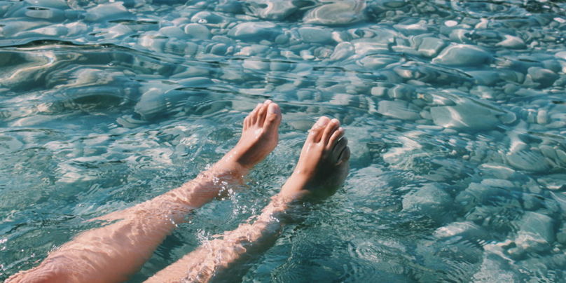 Highangle view of beautiful legs in a splashing pool