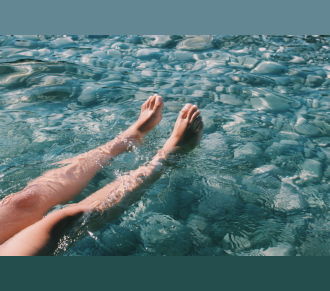 Highangle view of beautiful legs in a splashing pool