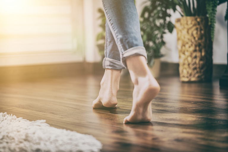 Person walking barefoot in a well heated room