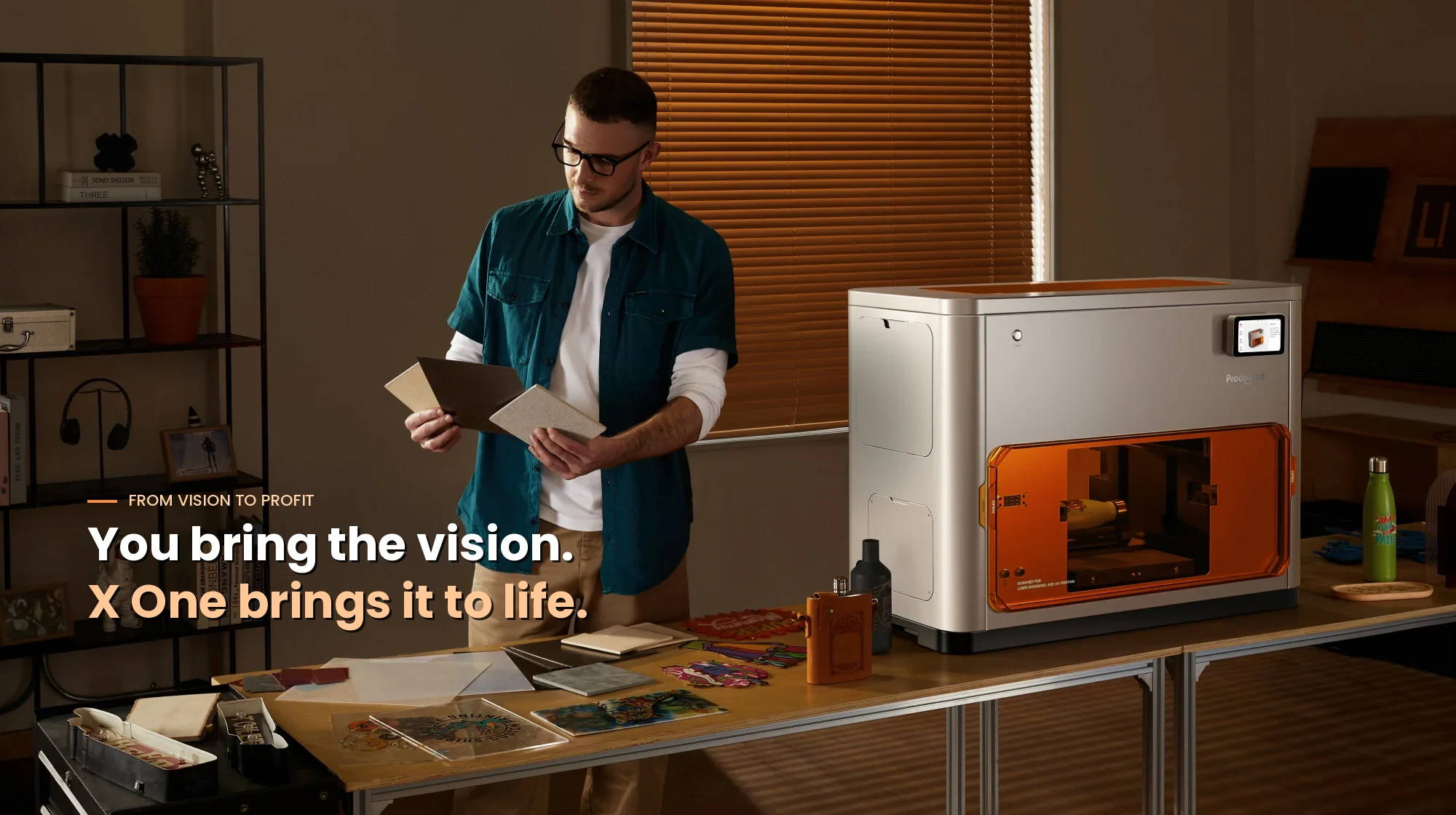 A creator inspecting material samples beside a working Procolored X One UV printer, with the orange laser engraving chamber actively processing inside — illustrating the seamless workflow from vision to finished product