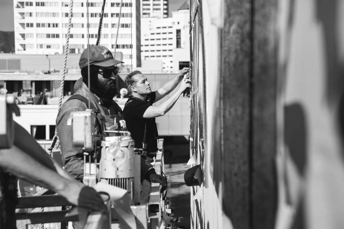 Shepard Fairey and team painting.