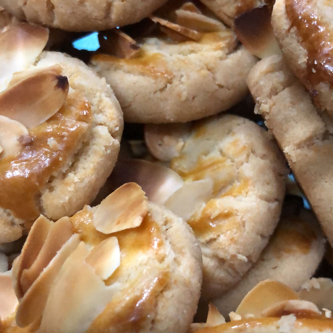 A decadent fresh almond cookie with almond flakes on top