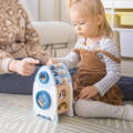 Little girl playing with the Montessori Learning Rocket. 