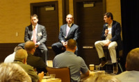 Shirl Penney, Elliot Weissbluth and Rudy Adolf sit, not too close, but side by side on the stage in Las Vegas. 