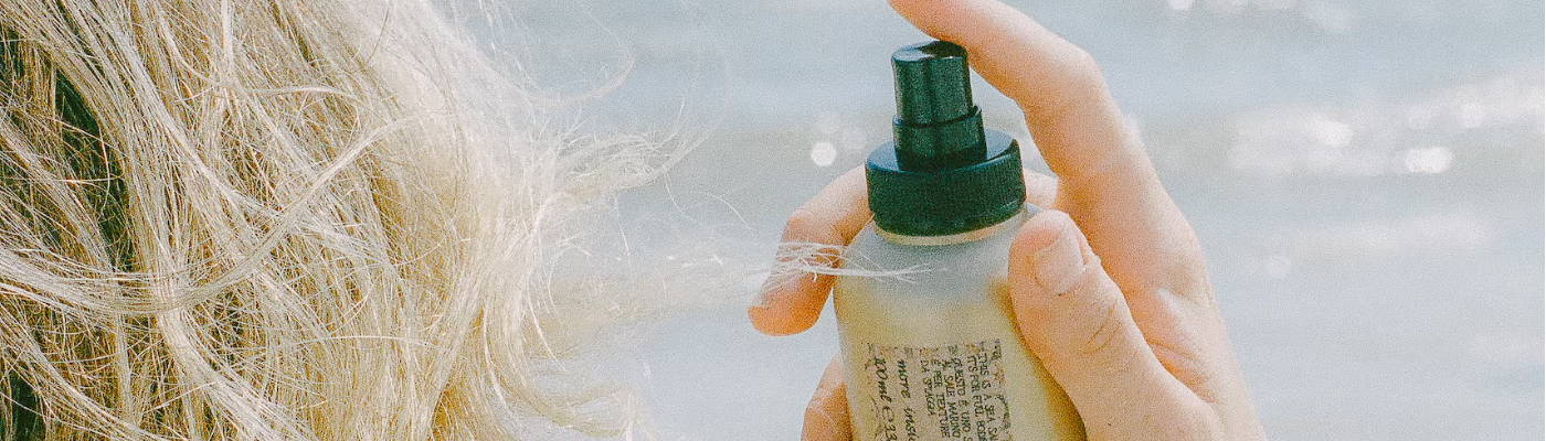 mini OI shampoo, OI milk, OI conditioner inside a packed suitcase