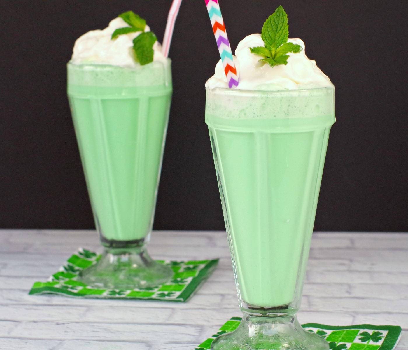Green peppermint drink topped with whipped cream 