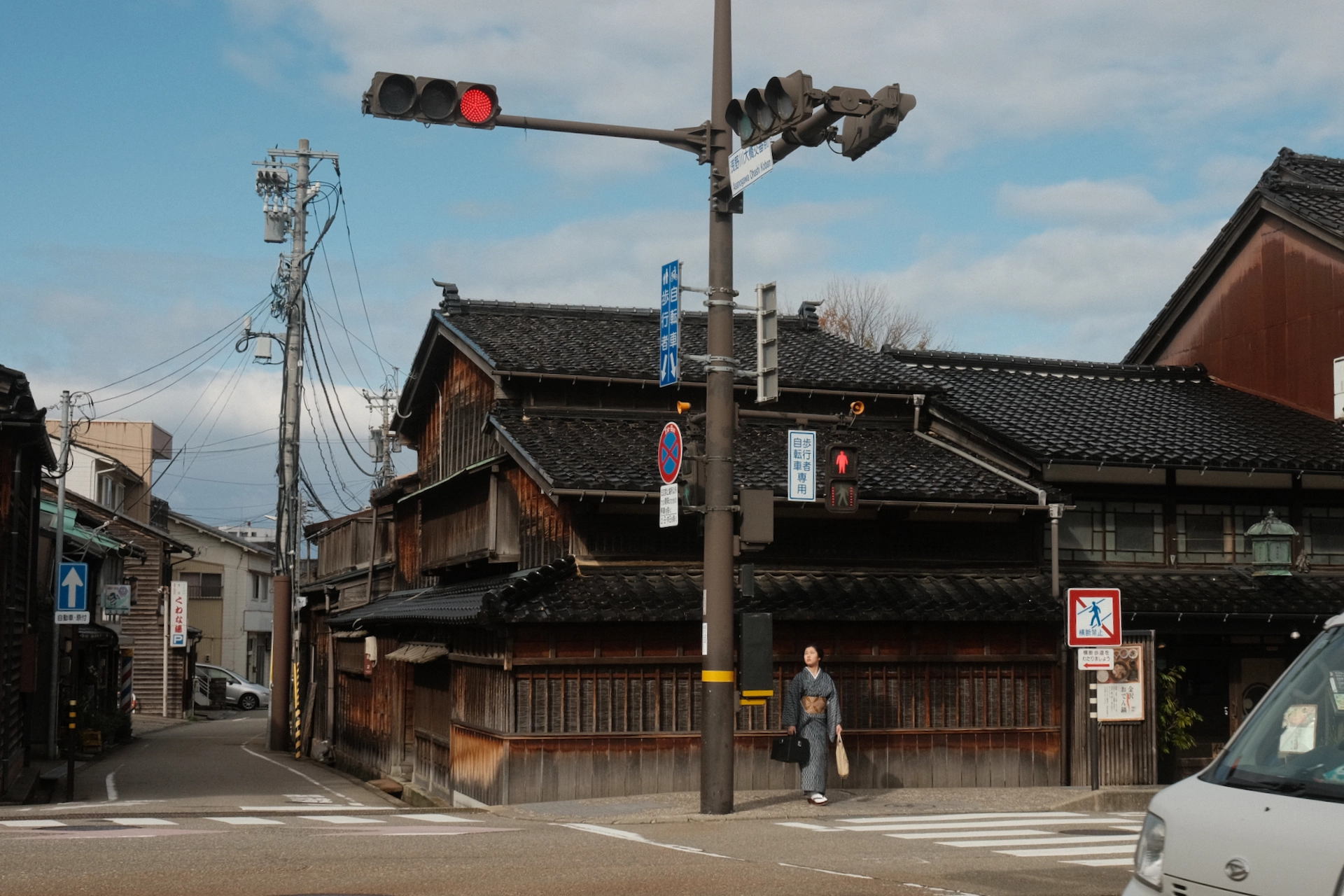 Woman waiting at a stop light in Kanazawa, Japan