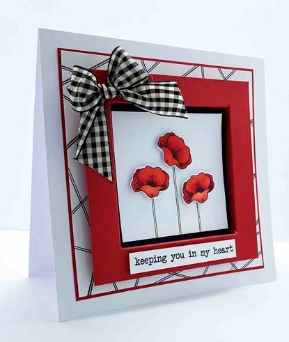 Square handcrafted card with stamped poppies from this months Stamp Club set, a red frame and a black and white checkered bow