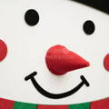 Close up showing a red nose that belongs to the Montessori Snowman.