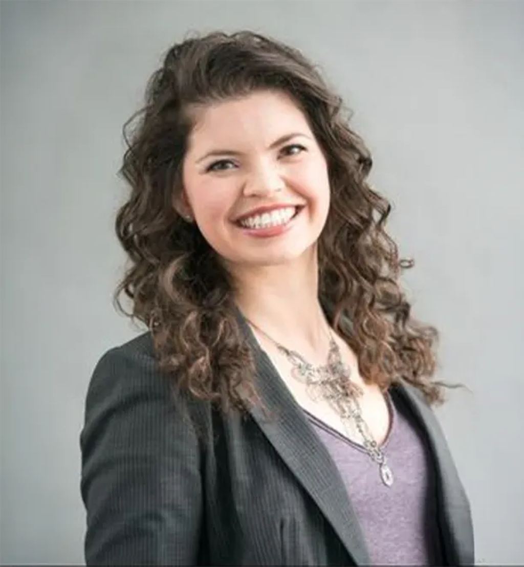 Portrait of Dr. Keila Roesner, ND, smiling confidently in professional attire against a neutral background.