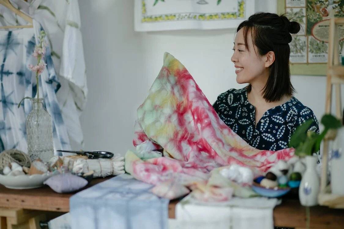 Woman holding a fabric while smiling